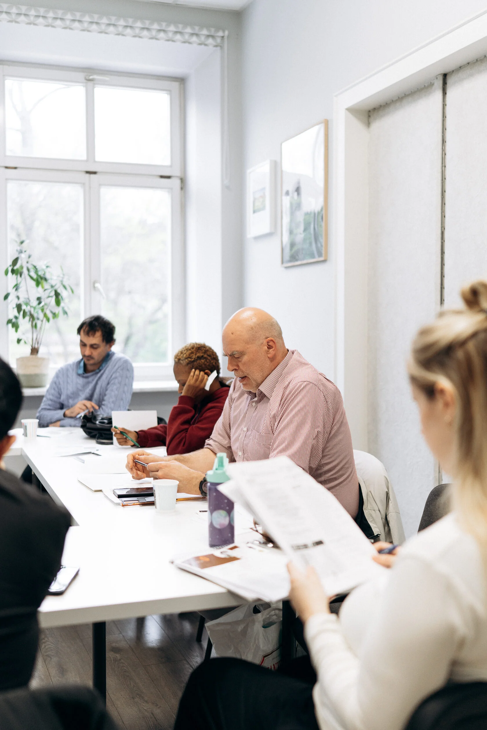 Adult students taking part in an in-person language class in Poland